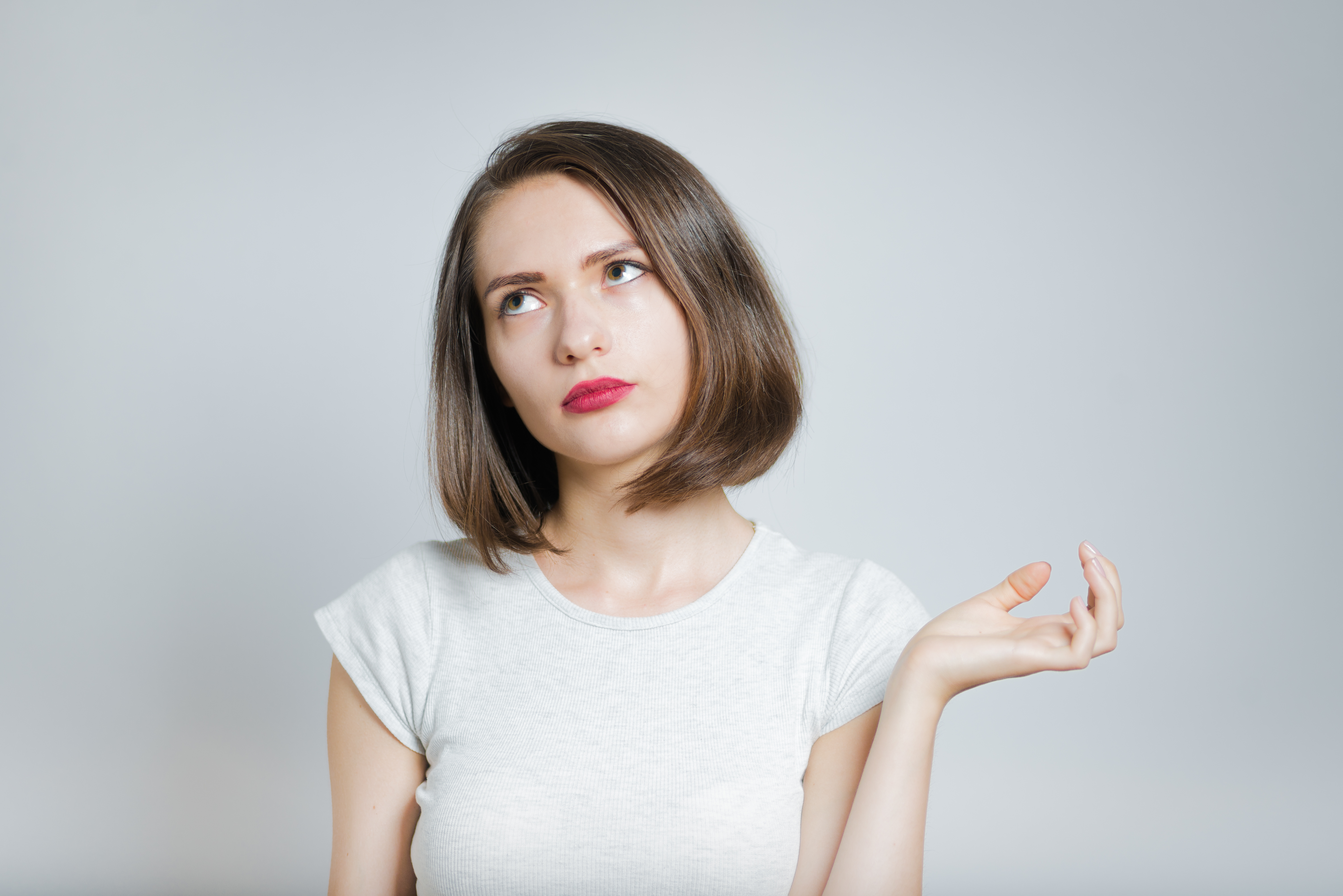 woman, appears, white, young, rolling eyes with one hand turned up like she can't believe what was said or she doesn't have patience for what someone else did