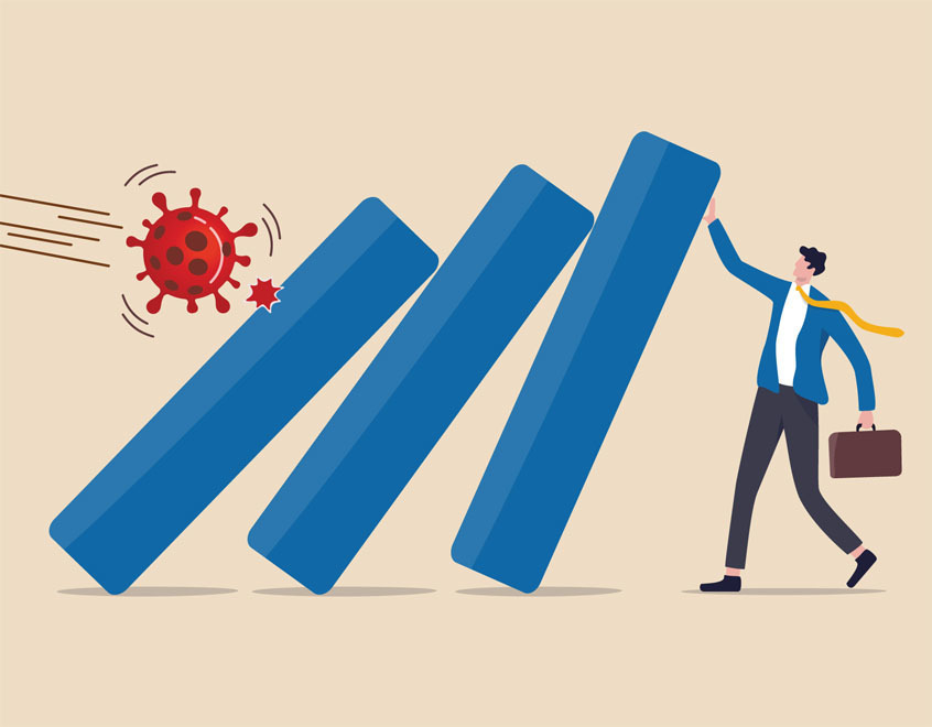 businessman holding up a barrier between him and a virus