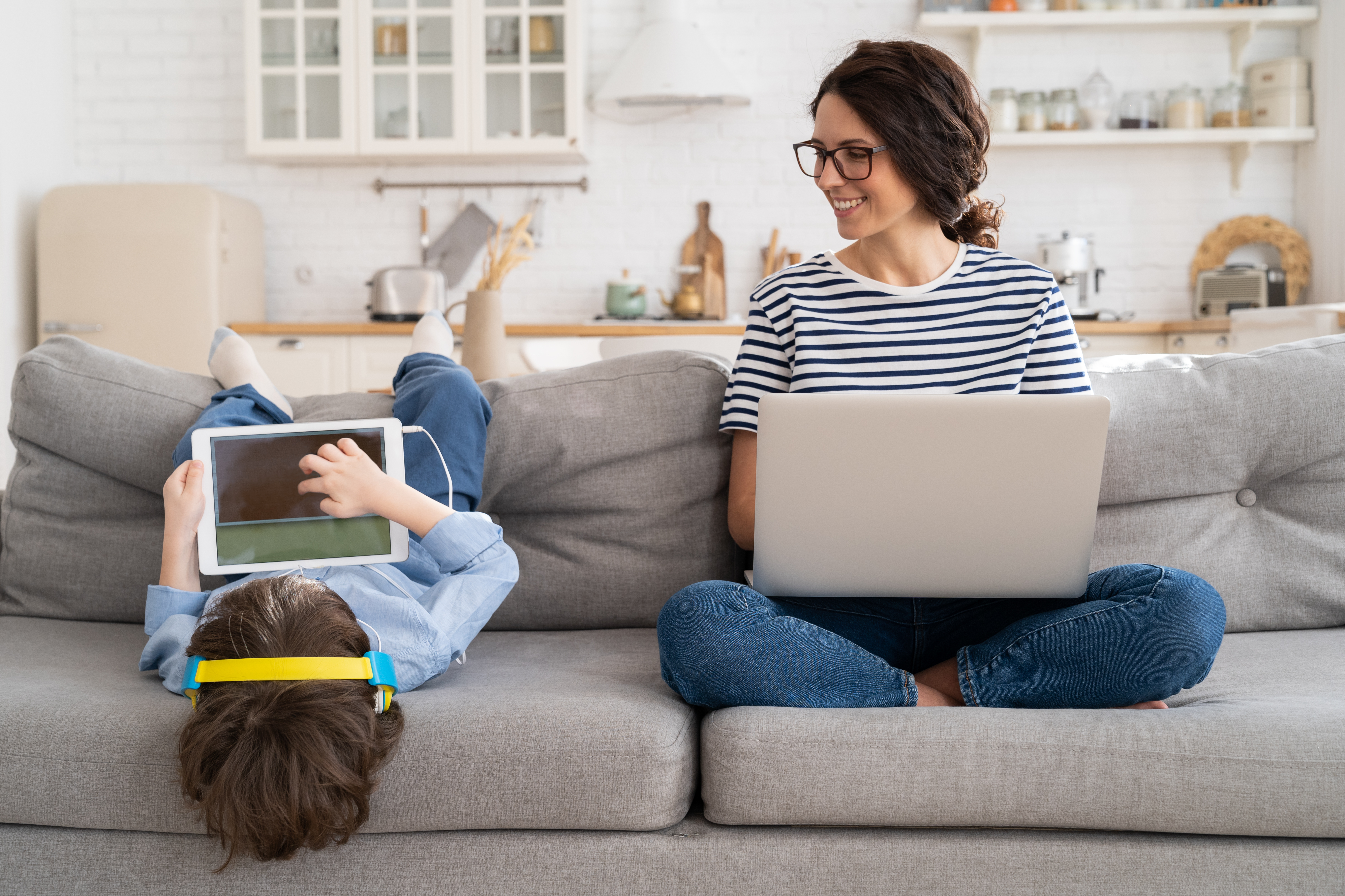Mother working remote with child. 