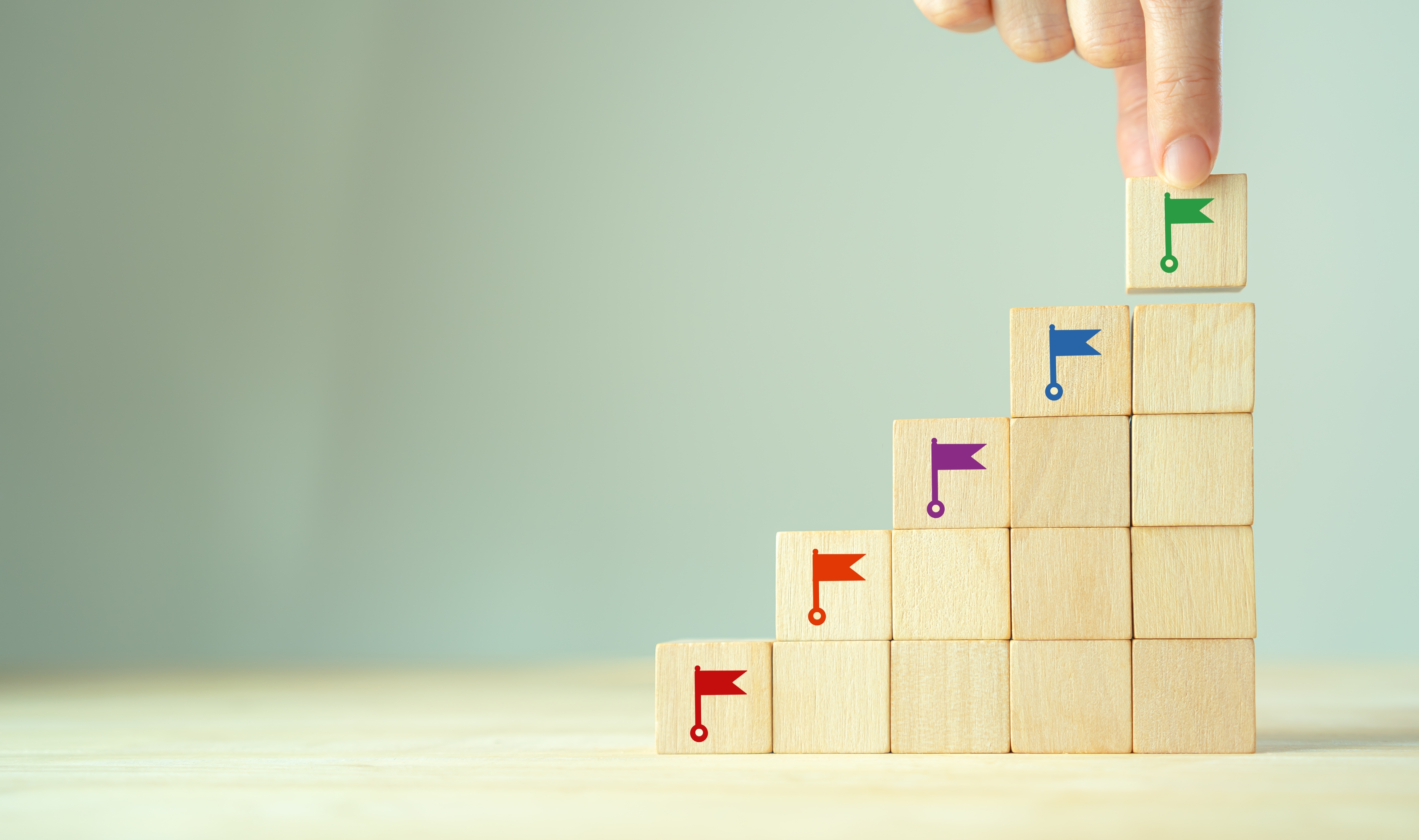 Blocks with colorful flags portraying milestones.