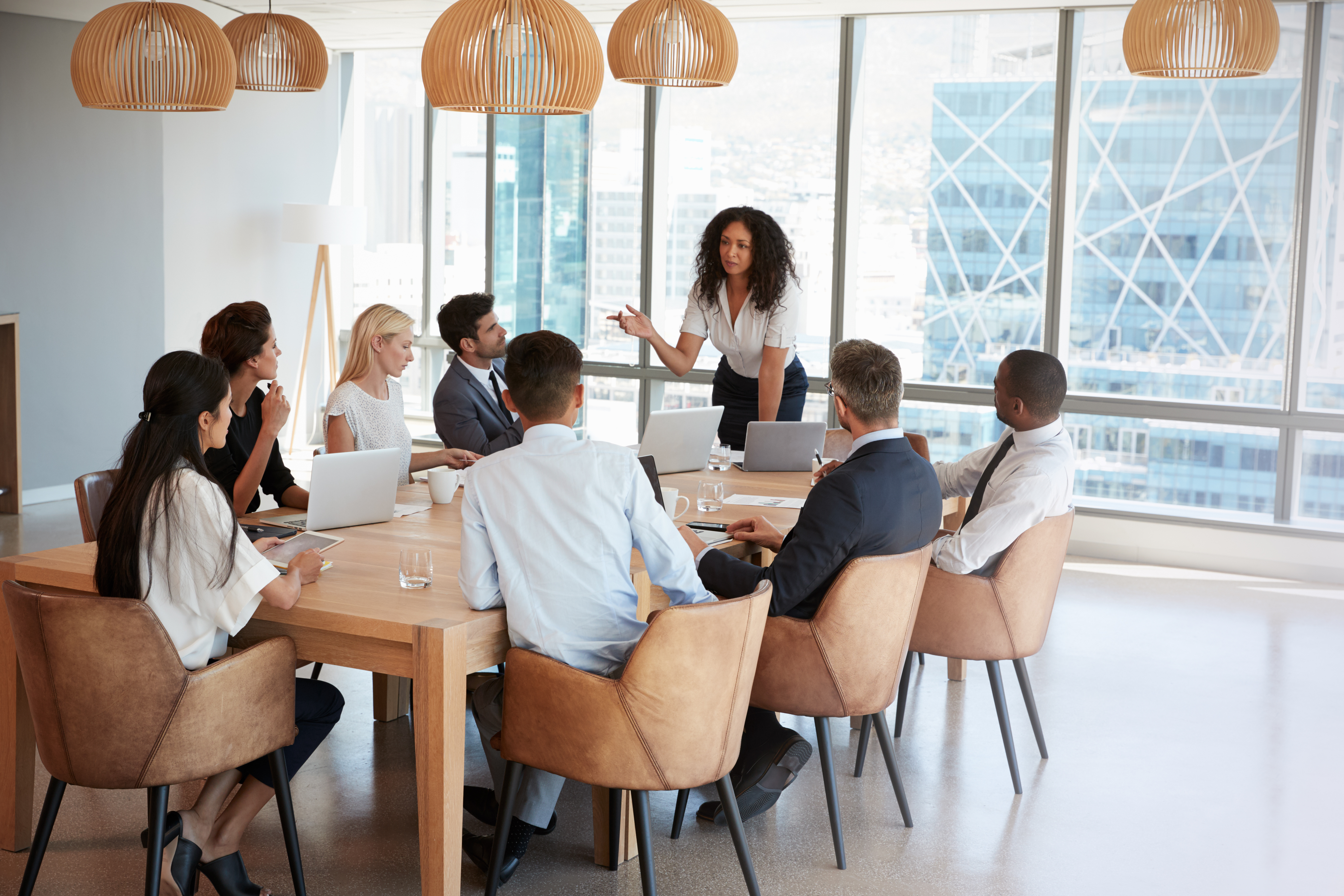 Female executive leading a meeting with colleagues. 