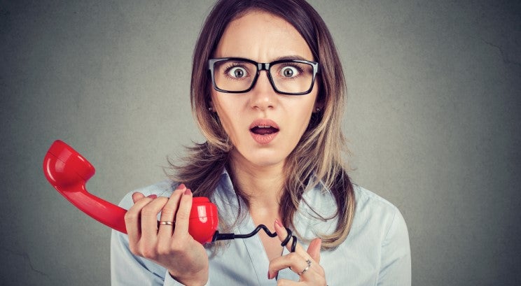 Surprised woman holding a phone