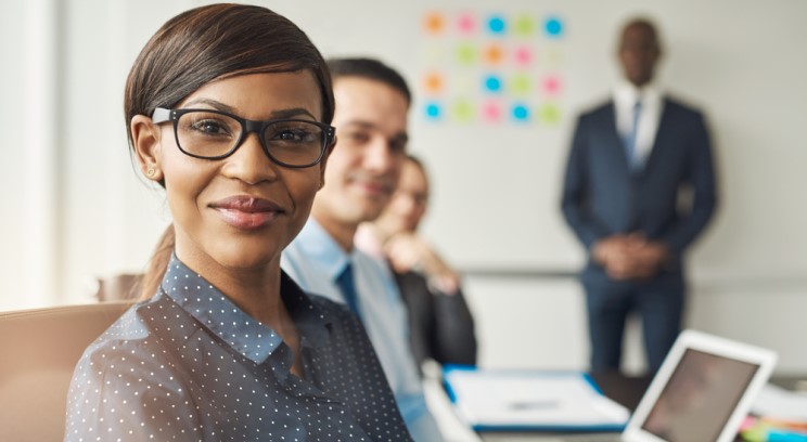 a woman in professional attire smiling at the camera