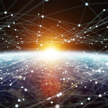 sun peaking over earth from space