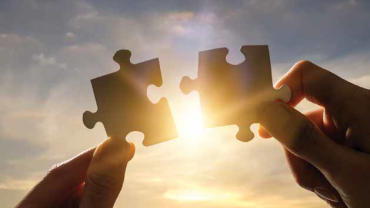 fitting two puzzle pieces together