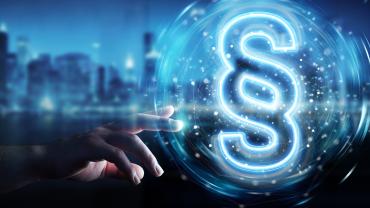 Hand reaching out to blue glowing section sign in front of a blue city skyline.