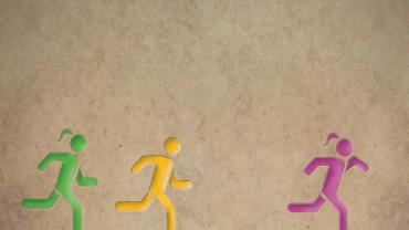 3 human figures running, two with ponytails and one without