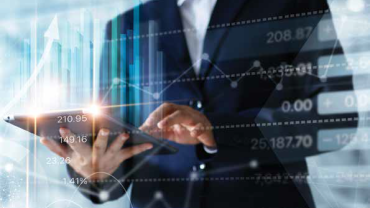 several graphs overlaying an image of a person in a suit holding a tablet