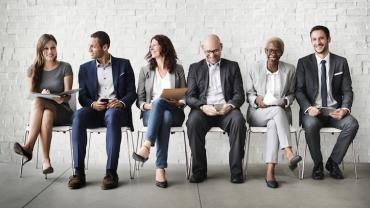 six diverse candidates seated side by side