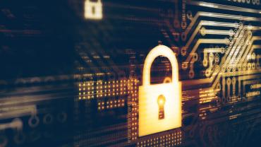 yellow/gold padlock in front of computer technology