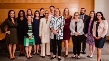 a group of 14 professionals pose as a group during the event