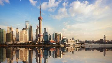 Shanghai's city skyline with multiple buildings on the water