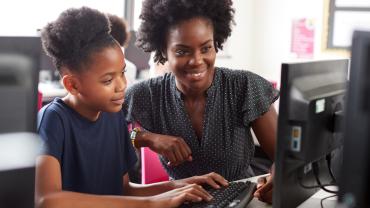 Teacher helping student