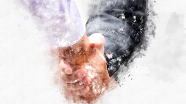 hands shaking with clothed arms showing, one hand white, the other light brown