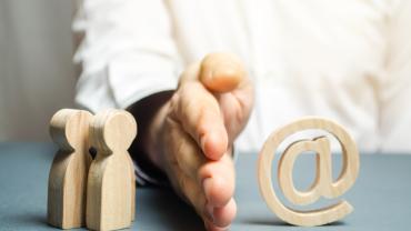 wooden figures and "@" to denote technology, with hand (White) dividing them