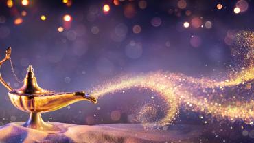 genie lamp with light spray coming out of it like genie is inside coming out