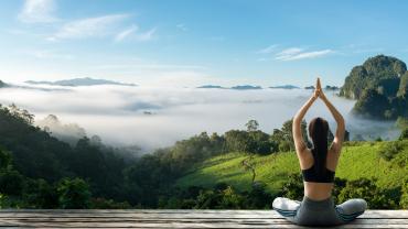 Young woman practicing yoga in nature. 