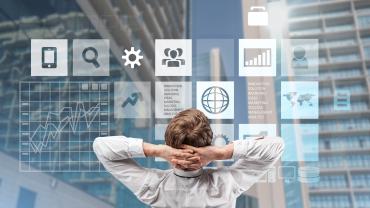 person, appears white, in chair, leaning back looking at window with icons representing, perhaps, types of work