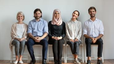 people sitting, dressed biz cas, mixed age, race, and gender