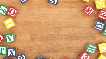 Lettered blocks on a wooden table. 