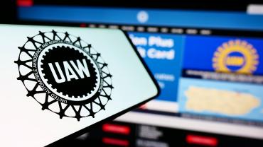 UAW worker's strike logo on a phone. 