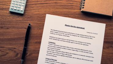 Photo of a pen and a master service agreement. 