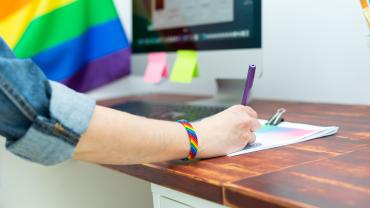 Pride flag and bracelet at work