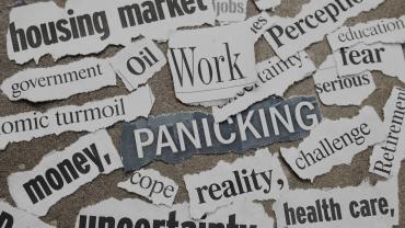 Scraps of newspaper headlines with words like Work, Panicking, Reality, and Uncertainty.
