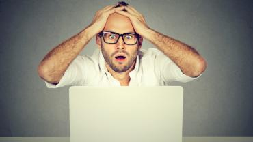 stressed man at laptop