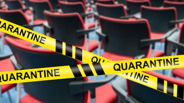 caution tape that reads QUARANTINE marking off rows of chairs