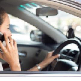 Woman taking a work call from her car