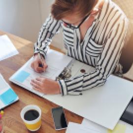 Woman writing in binder