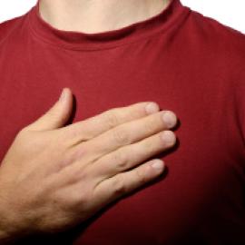 person, white skin, just showing chest with hand over it like pledging