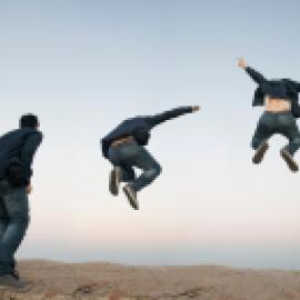 looks like man about to jump outside, horizon in back, jumps, jumps higher with arms up