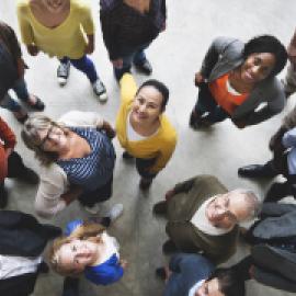 a group of diverse people standing together and looking up