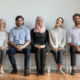 people sitting, dressed biz cas, mixed age, race, and gender