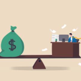 see saw with money bag with dollar sign on one end and desk with person working, papers flying, on other