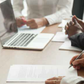 person writing in a meeting