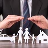 a man protecting outlines of a car, family, and a house with his hands