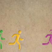 3 human figures running, two with ponytails and one without