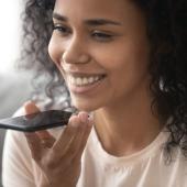 woman smiling and holding phone