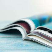 Magazines stacked on a table.