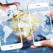 two hands hold phones next to each other to connect with a transparent map overlaid atop of them to show connectivity