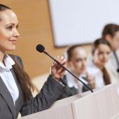 woman standing at the podium ready to speak