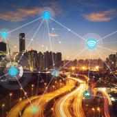 city lit up at night with a network of lights connecting various hubs