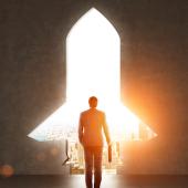 a doorway in the shape of a rocket ship frames a man walking out into the city holding a briefcase