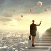 woman holding a briefcase walking up floating stairs above a city landscape