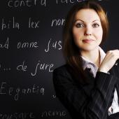 woman standing in front of a chalk board