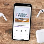 Smart phone with earbuds on a wood table