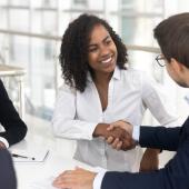Group of multiracial business people shaking hands in a board room.